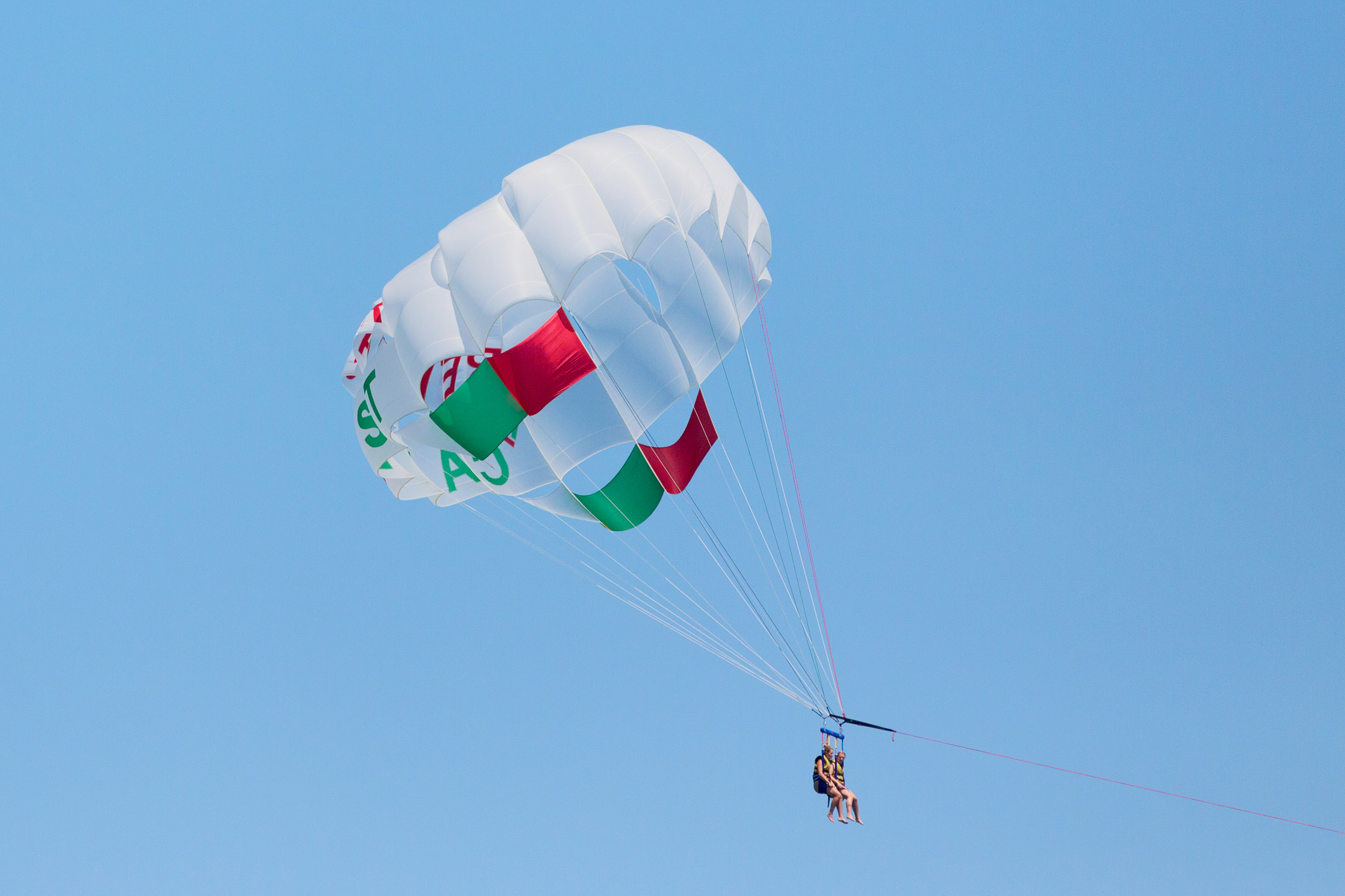 person in a white parachute during daytime